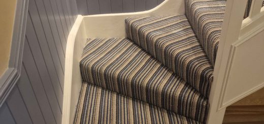 black and blue striped stair runner carpet fitted on stairs