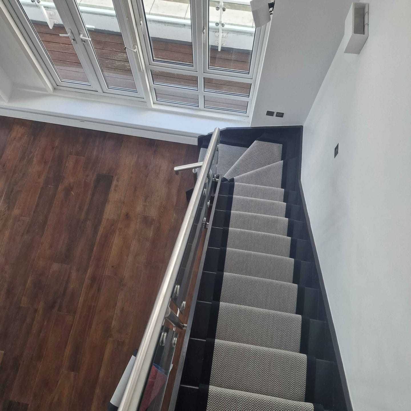 Black faux sisal runner on stairs in penthouse