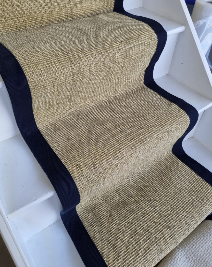 A sisal stair runner with a navy border