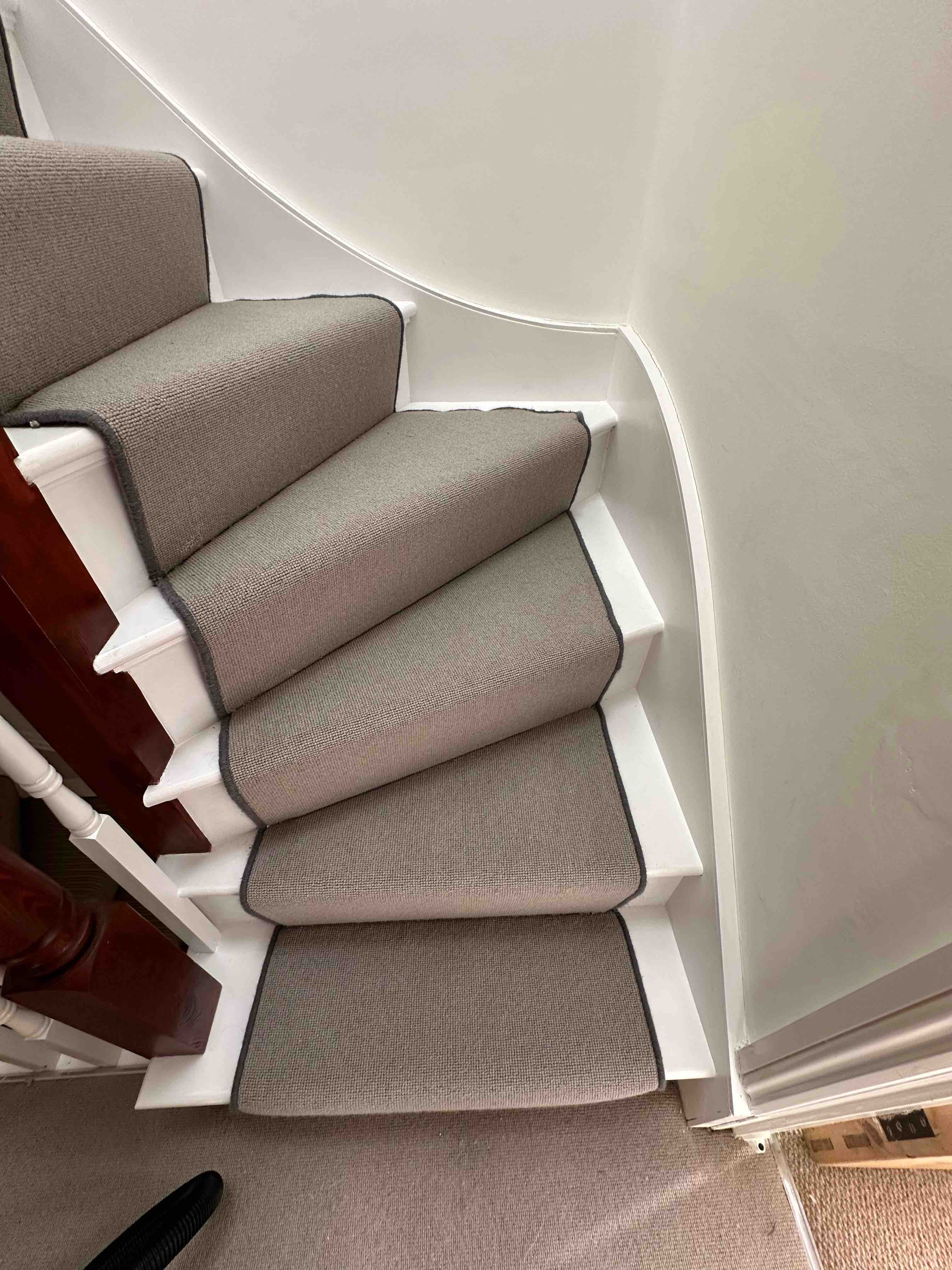 Greige faux sisal stair runner with a dark grey whipped edge