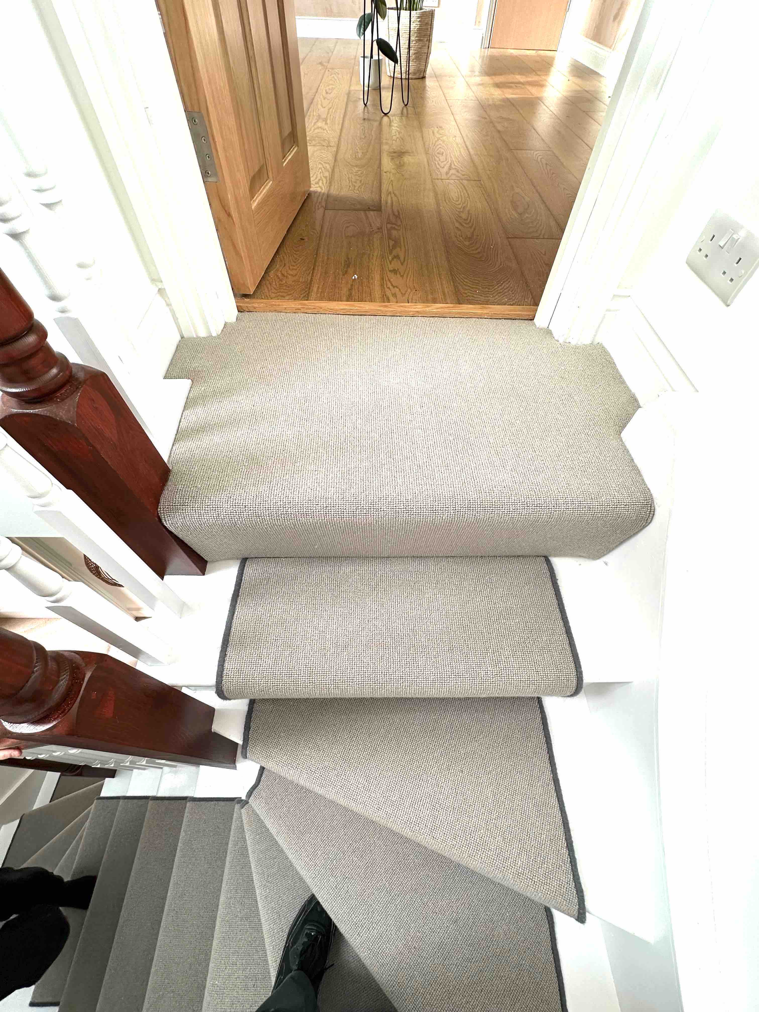 Greige faux sisal stair runner with a dark grey whipped edge
