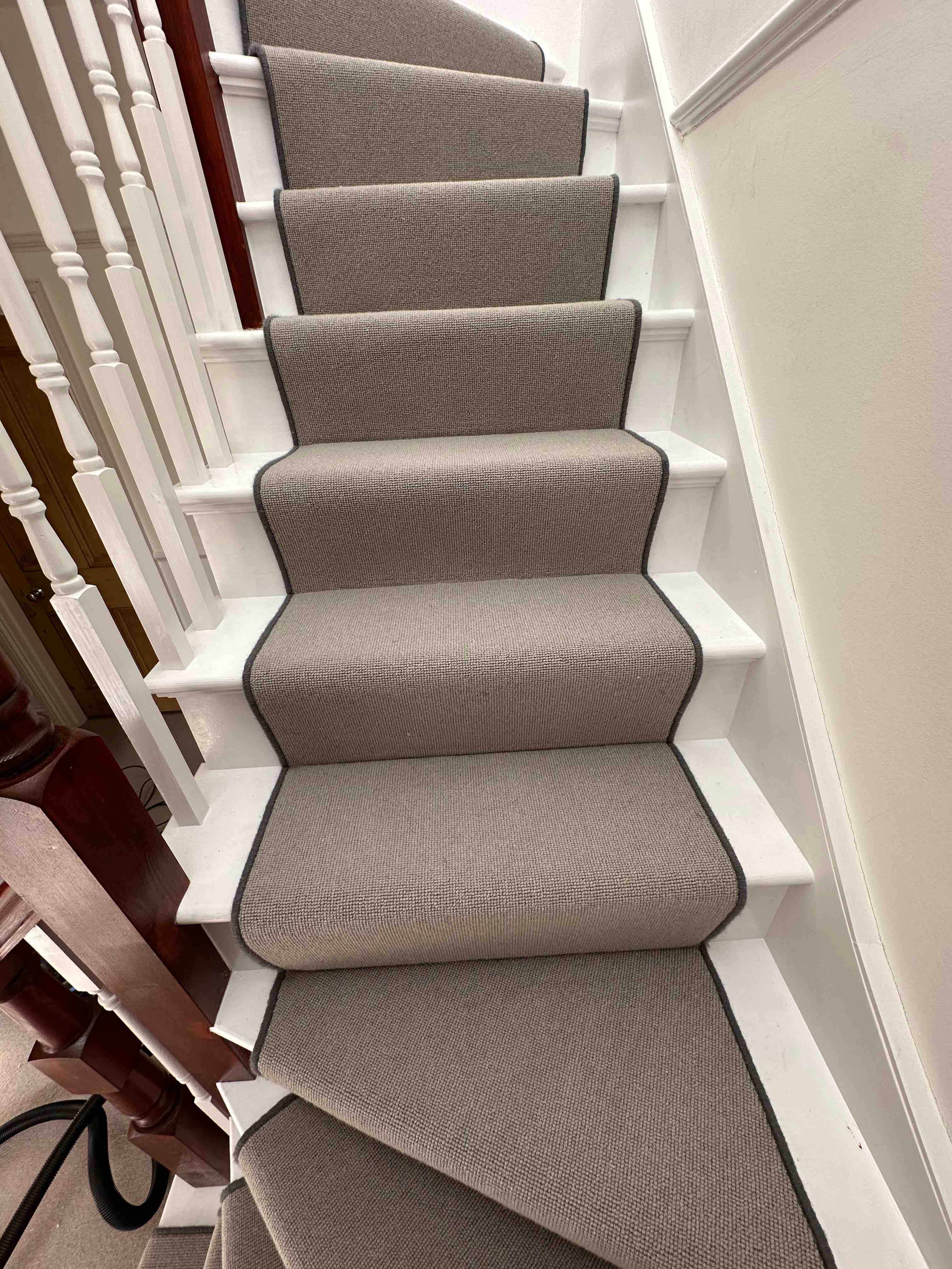 Greige faux sisal stair runner with a dark grey whipped edge