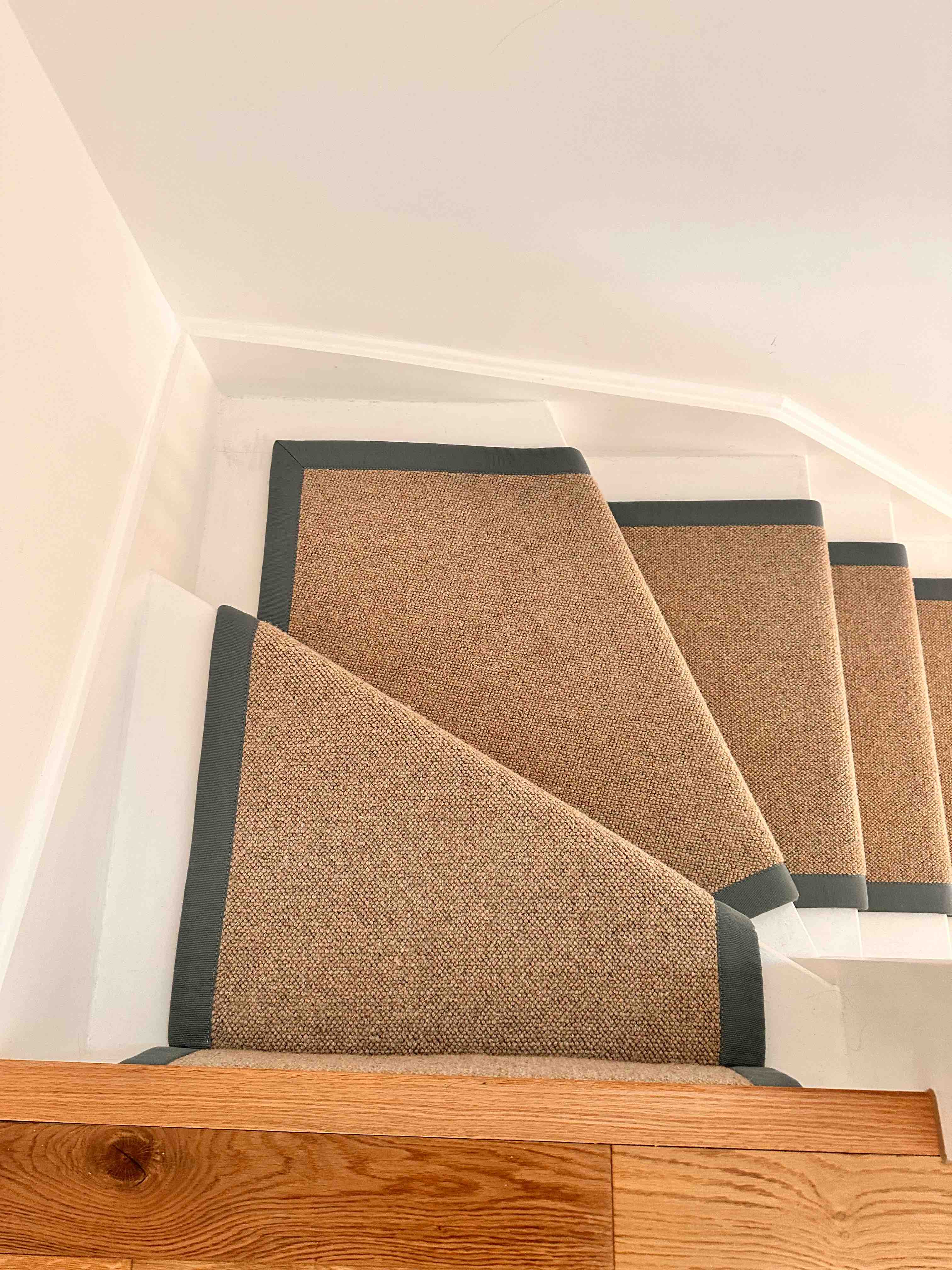 Natural bouclé stair runner with a black cotton border
