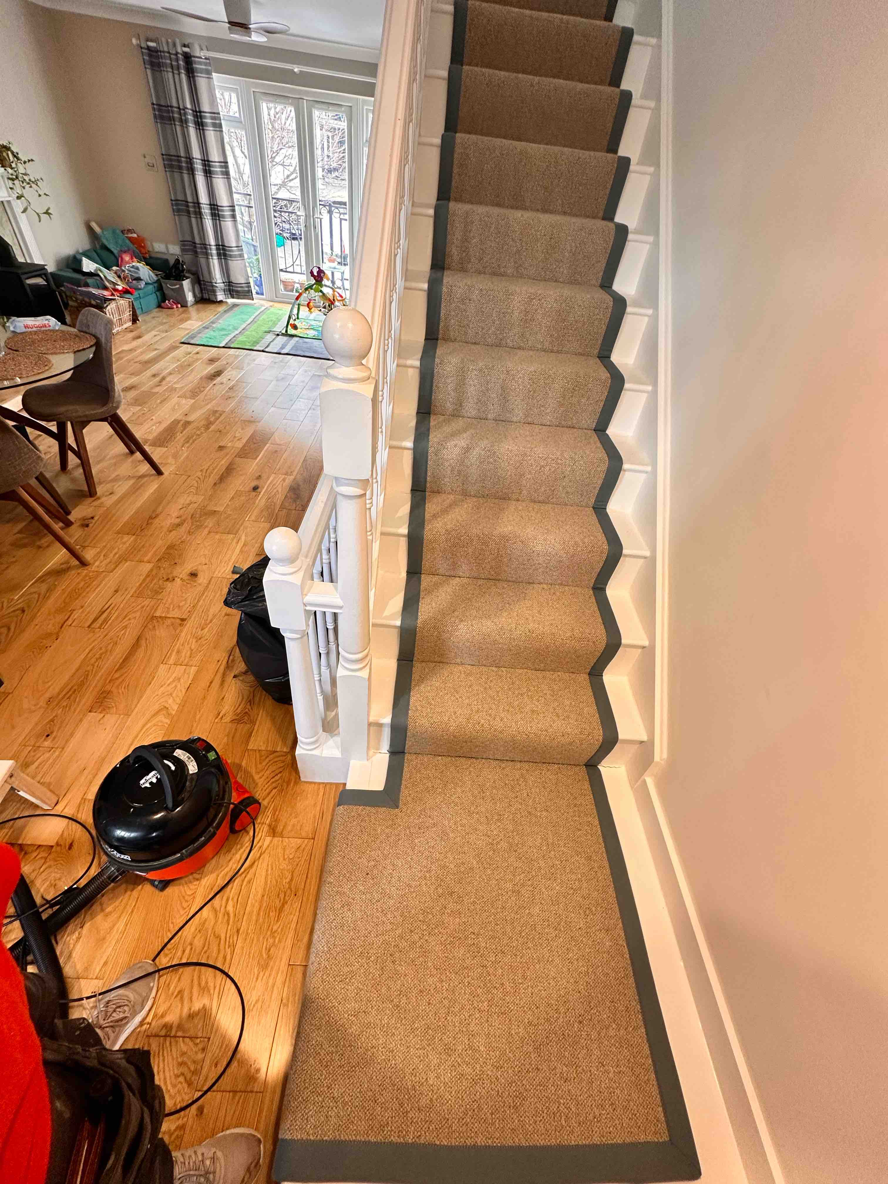 Natural bouclé stair runner with a black cotton border